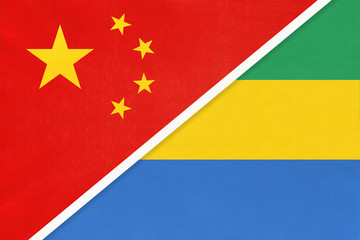 China or PRC vs Gabon national flag from textile. Relationship between Asian and African countries.