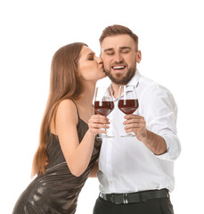 Happy couple with glasses of wine on white background