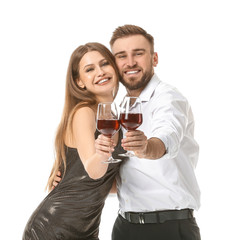 Happy couple with glasses of wine on white background