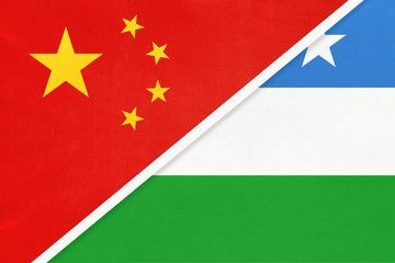 China or PRC vs Puntland State of Somalia national flag from textile. Relationship between Asian and African countries.