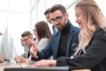 project Manager and business team sitting at the Desk