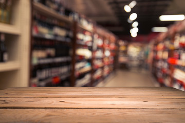 Supermarket background, Counter over blur grocery background, Wooden desk, table, shelf and blur woman shopping at supermarket, Wood counter for grocery store retail product display backdrop, template
