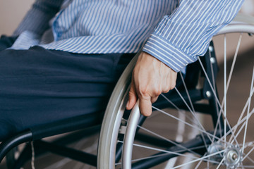 Unrecognizable disabled woman in wheelchair at home. Recovery and healthcare concepts.