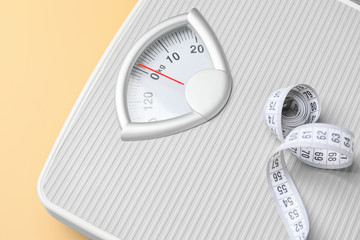 Naklejka premium Weight scales with measuring tape on color background, closeup. Slimming concept