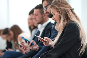 group of young people waiting, sitting in the queue