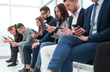 group of casual young people using their gadgets .