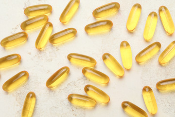 Fish oil capsules on light background