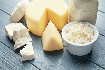 Different dairy products on color wooden background
