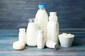 Different dairy products on color wooden background