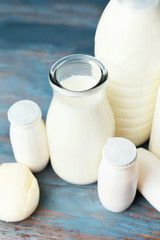 Different dairy products on color wooden background