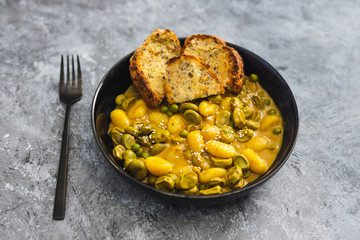 plant-based food, vegan potato gnocchi with nutritional yeast sauce and broad beans