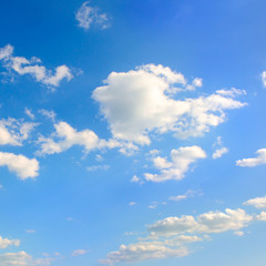 White cumulus clouds in blue sky .