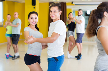 Fototapeta na wymiar Cheerful dancing couples learning salsa