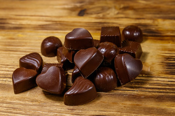 Tasty chocolate candies on wooden table