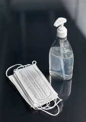 hygiene and disinfection concept - close up of hand sanitizer or liquid soap and face protective...