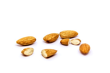 A close up of almond seeds on white isolated background. food and kitchen concept.