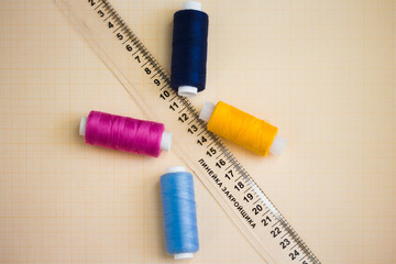 thread in spools and cutter line for sewing