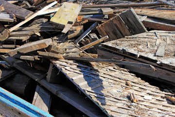 Heap of old damaged wooden boards. Dirty broken planks. 