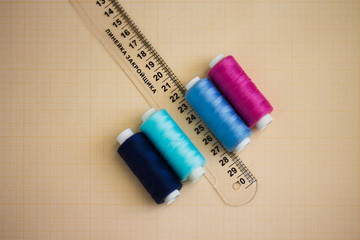 thread in spools and cutter line for sewing