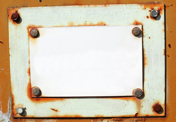 Blank rusty old metal plate on the door