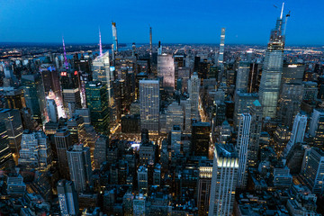 New York City Manhattan Times Square panorama aerial view at night with office building skyscrapers skyline illuminated by Hudson River.