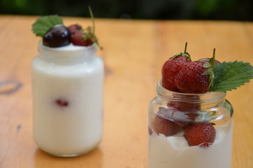 Healthy breakfast home made pudding or yogurt or granola, strawberries, cherry, berry,  yogurt in a...