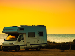 Camper car on beach at sunrise