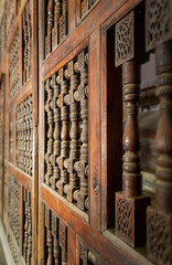 Angle view of interleaved wooden ornate wall - Mashrabiya - at abandoned building