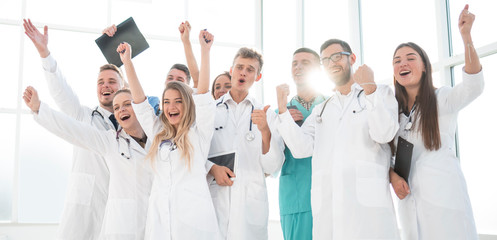 group of diverse medical employees showing their success