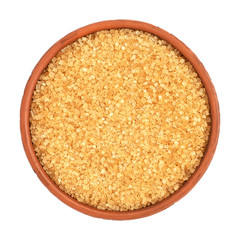 Brown cane sugar in a bowl isolated on white background, top view.