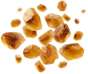 Caramelized sugar levitates on a white background