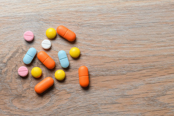 Assorted color tablets close-up on the table. Concept of protection and treatment of coronavirus infection. Copy space.