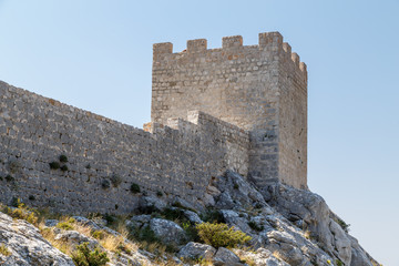 Fototapeta na wymiar Medieval Starigrad Fortress standing above Omis town in Dalmatia, Croatia
