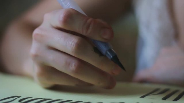 Elm - an Old Slavonic writing, performed with a brush and black ink on paper in a room in daylight