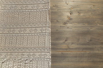 Vintage lace pattern cloth and wood board texture background. retro ornate tablecloth on wooden table surface, top view.