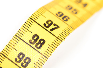 Close-up of a yellow measuring tape isolated on white - 98