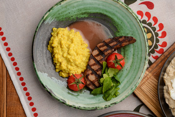 Grilled Steak Meat. Barbecue steak served on a green plate. Ukrainian cuisine.