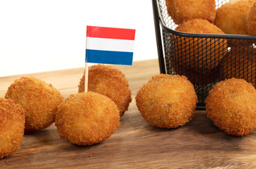 Dutch traditional snack bitterbal on a serving board, dutch flag