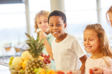 African boy at the buffet of the cafeteria