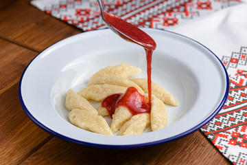 Dumplings, filled with cherries, berries. Pierogi, varenyky, vareniki, pyrohy - dumplings with filling.