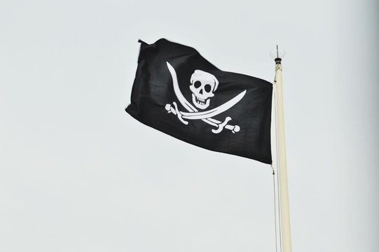 Low Angle View Of Pirates Flag Against Clear Sky