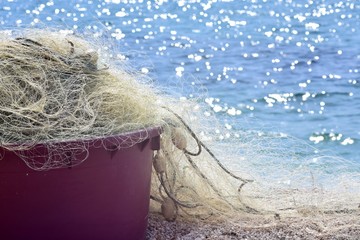 Close up view of fishing net at the beach whit beautiful sea landscape as background