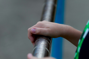 Body parts: a child's hand holding a crossbar