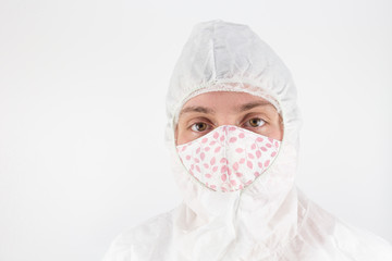 Woman in protective medical clothing wearing a homemade cloth face mask