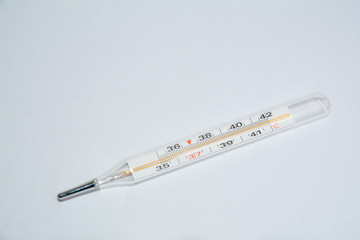 On white surface in center is placed a thermometer to measure the temperature. Glass mercury...