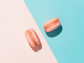 Pink macarons with copy space. Row of perfect french macarons or macaroons on pink and blue...