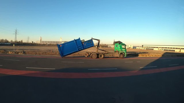 The garbage truck takes the trash can. work of municipal services