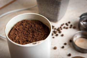 Grinding black pepper in a coffee grinder.