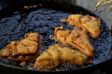 Bread Pakoda While Frying in Oil With Selective Focus, It is a Very Popular Indian Street Food or Snack