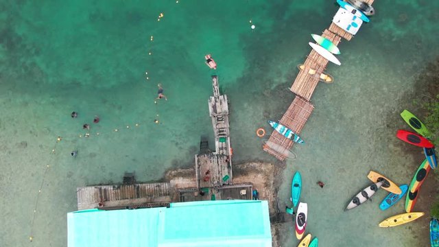 Drone Aerial View Of A Man Doing A Jump Of A Diving Board Cliff Jumping Whilst Doing A Backflip Into The Ocean Whilst On Holiday At Sugba Blue Lagoon Philippines Siargao